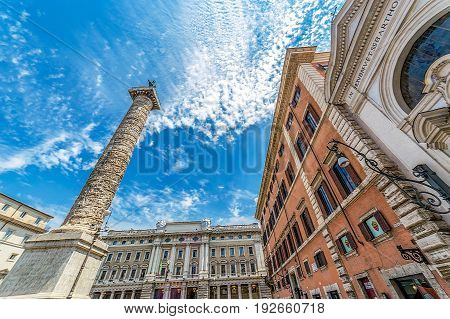 ROME ITALY - JUNE 1 2017: Column of emperor Marco Aurelio in Piazza Colonna with engraved the story of the campaign conducted by against the germans. Saint Paul bronze statue at the top.