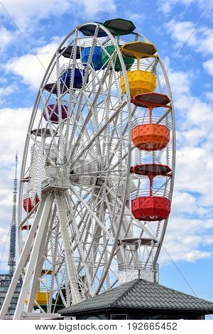 Ferris wheel and cloudy sky at mount Tibidabo in Barcelona, Spain