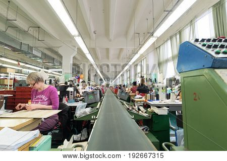 MOSCOW, RUSSIA - FEBRUARY 21, 2017: Moscow shoe factory JSC RALF RINGER . Female and male workers on a sewing machine.