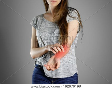 Girl In Grey Shirt Scratching His Arm. Scabies. Scratch The Hand. Isolated