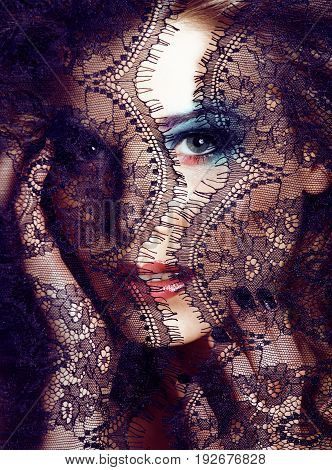 portrait of beauty young woman through lace close up mistery makeup sexy, fashion people concept close up