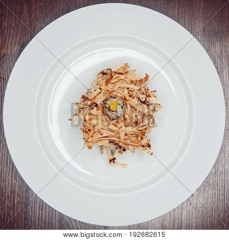 Salad in the form of a nest and decorated with quail eggs.