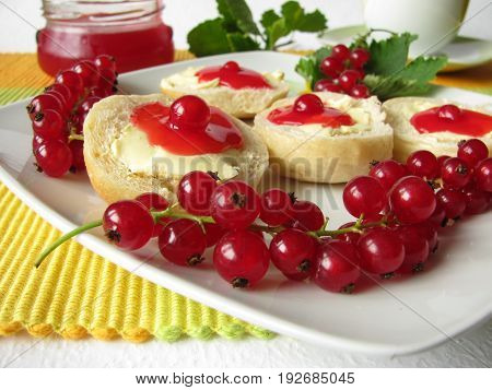 Fresh baked rolls with currant jelly and red berries