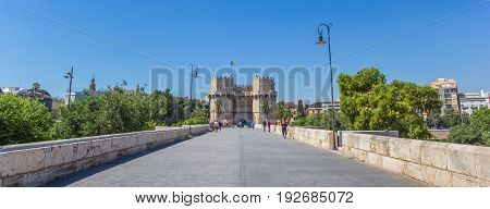 VALENCIA, SPAIN - JUNE 12, 2017: Panorama of people walking the Serranos brigde towards the historic city gate in Valencia, Spain