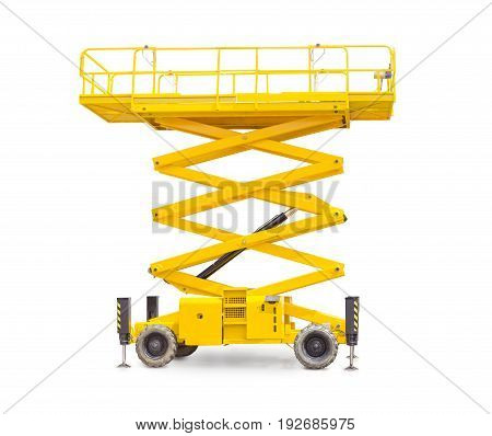Yellow scissor wheeled lift on a light background