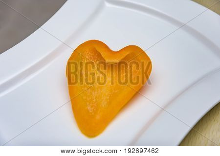 fresh orange peppers Orange pepper on a plate Pepper carved heart
