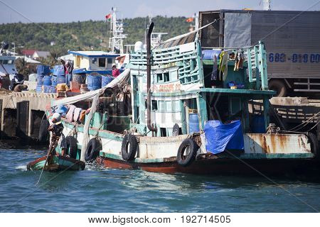 PHU QUOC, VIETNAM - March 21, 2017: Lifestyle of fishermen on their boats in An Thoi pier village, Phu Quoc island, Vietnam