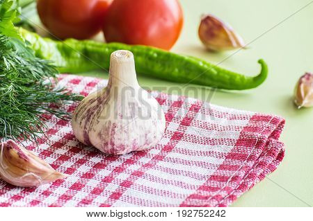 ripe garlic fruits with green parsley leaves isolated on white background
