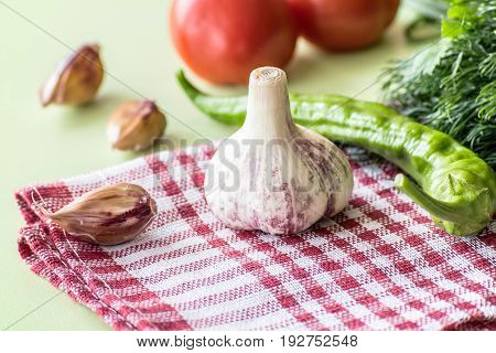 ripe garlic fruits with green parsley leaves isolated on white background