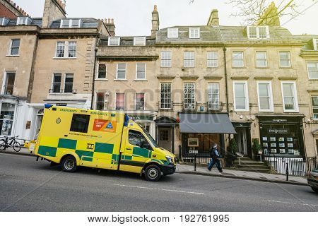 BATH, UNITED KINGDOM - MAR 7, 2017: Yellow British UK ambulance nhs ambulance, south western ambulance service fast motion in Bath, United kingdom