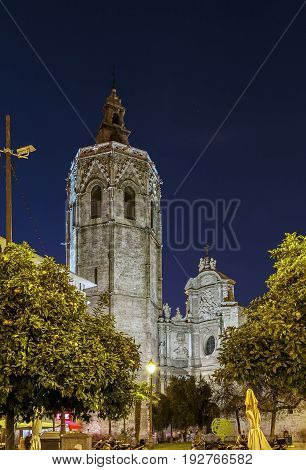 View of Valencia Cathedral or Basilica of the Assumption of Our Lady of Valencia from Plaza de la Reina in evening Spain