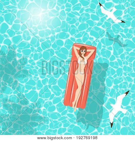 Woman in white bikini relaxing on red air mattress floating in clear turquoise sea water in summer with shadow of coconut trees and seagulls from top view