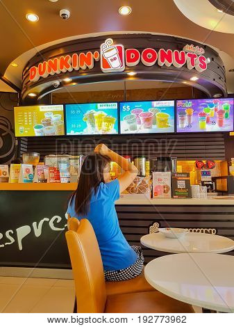 CHIANG MAI THAILAND - JUNE 24 : unidentified woman wait to buy food in Dunkin Donuts shop on June 24 2017 in Chiang mai Thailand.