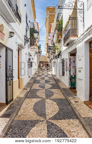 ALTEA, SPAIN - JUNE 09, 2017: Narrow shopping street in the center of Altea, Spain