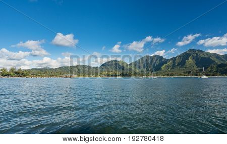 Afternoon from boat trip at Hanalei Bay and pier with the Na Pali coast in the background near Hanalei, Kauai, Hawaii