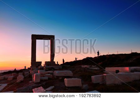 Portara ruins entrance of ancient temple of Apollo at sunset on Naxos island Greece