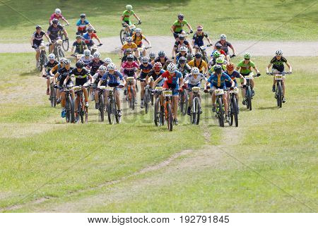 STOCKHOLM SWEDEN - JUNE 11 2017: Large group of fighting mountain bike cyclists i cycling uphill at Lida Loop Mountain bike Race audience in background. June 11 2017 in Stockholm Sweden