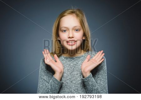 Closeup Portrait of little girl going surprise on gray background.