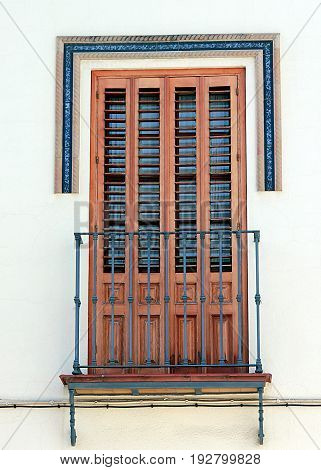 Beautiful window with shutters and small balcony in the town of Dos Hermanos, Andalusia, Spain