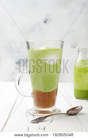 Matcha latte with salted caramel in tall glass.