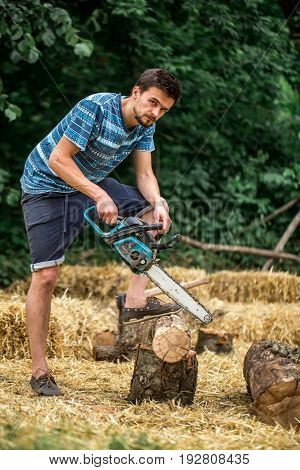 Man Chopping Wood With A Chainsaw
