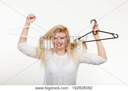Blonde Woman Holding Hair On Clothes Hanger