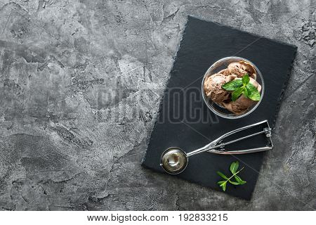 Chocolate ice cream served in cute piala with lovely modern scoop, mint leaves, copyspace, topview