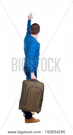 back view of  pointing man  with suitcase. brunette guy pointing .  backside view of person. Isolated over white background. guy with a travel bag on wheels looking at something at the top