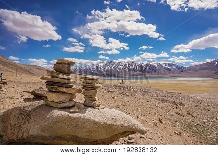 Sort meditation stones. Sort of stone on the hill with snow peaks view and Beautiful  blue sky.