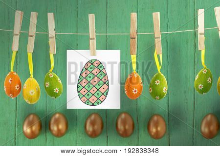 PE047_eggs_02_bs_nf against golden easter eggs arranged on wooden surface