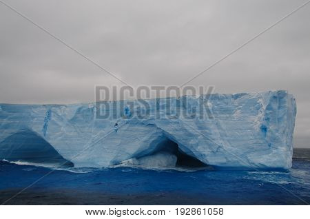 A large tabular iceberg floating in the southern atlantic ocean, near Antarctica.