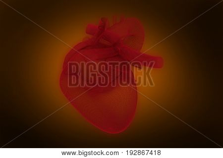 Digitally generated image of 3d human heart against orange background with vignette