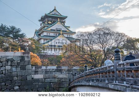 OsakaJapan - November 28 2015 : Unidentified tourists visit Osaka Castle in Osaka with autumn leaves. Japan.