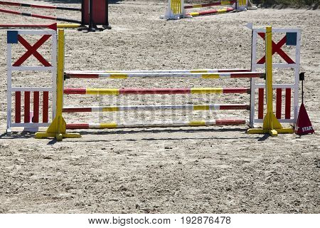 Colorful wooden barriers on the ground for jumping horses and riders