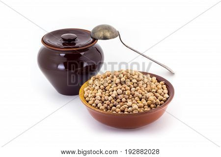 Still life of chick peas in ceramic pial, ceramic pot, old spoon , isolated on white background
