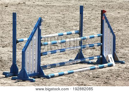 Colorful wooden barriers on the ground for jumping horses and riders