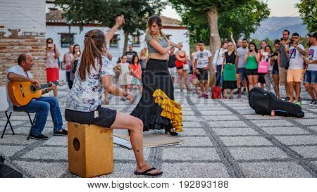 GRANADA, SPAIN - JUNE 23: Unidentified flamenco dancer dances for tourists in St. Nicolas viewpoint to Alhambra in Granada on June 23, 2017 in Spain