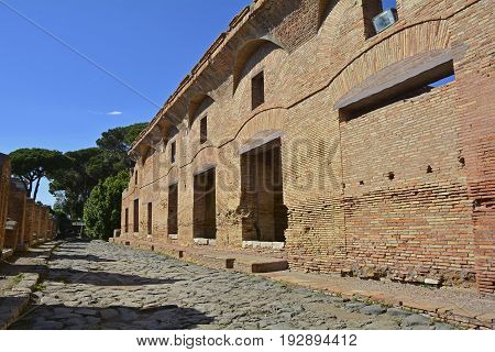 The ruins insulae apartment buildings in Ostia Antica near Rome Italy. It was Rome's ancient port before the river silted it fell into decay with the end of the Roman empire and was abandoned in the 9th century.