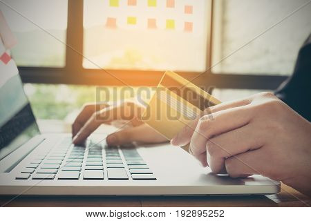 Online payment Man's hands holding a credit card and using smartphone and choose some product what him want for online shopping.