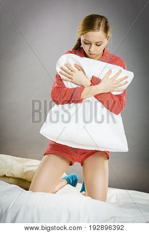 Sad Depressed Girl In Bed Gripping Pillow
