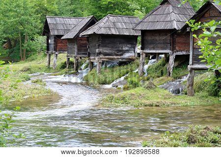 Wooden huts housing the traditional watermills at Pliva Lake Bosnia and Herzegovina