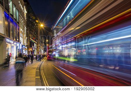 London UK October 05 2016: Crowded Oxford street with city bus passing by at night