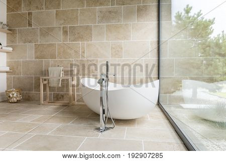Bathroom with big window and wooden accesorises