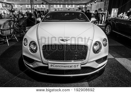 MAASTRICHT NETHERLANDS - JANUARY 14 2016: Personal luxury car Bentley Continental GT V8S since 2016. Black and white. International Exhibition InterClassics & Topmobiel 2016