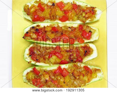 stuffed marrow vegetable and tomato with parsley and fennel on the plate