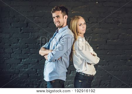 business team male and female formed of young businessmen standing over a dark background.