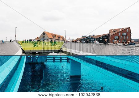 Copenhagen Denmark - August 12 2016: Inderhavnsbroen the Inner Harbour Bridge is a bridge across the Copenhagen inner harbour combined pedestrian and bicyclist bridge a cloudy day of summer.
