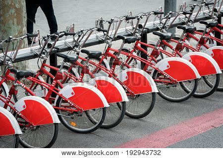 Parked bicycles on street of Barcelona town, Spain