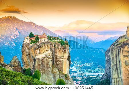 Beautiful landscape at sunrise with traditional mountain and Holy Trinity monastery in Meteora place Greece Europe