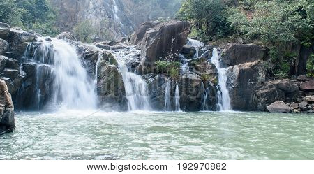 Lodh waterfall with sun rays in Jharkhand,India. Lens flare and light leak.